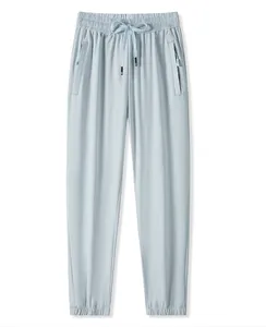 Pantalon de jogging en soie glacée bleue avec taille élastique et poches zippées
