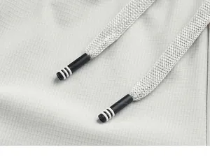 Détail du pantalon en soie glacée gris clair montrant le cordon et la texture quadrillée