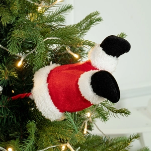 Funny plush Santa legs decoration stuck in Christmas tree with white faux fur trim