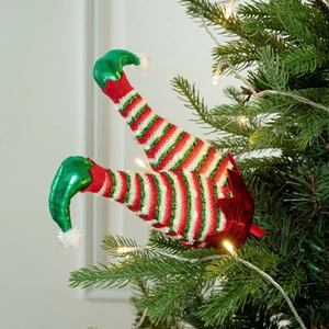 Detail of Christmas elf leg tree topper featuring red white stripes and green sequins