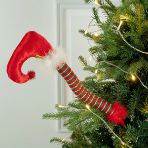 Detailed view of striped elf legs Christmas tree topper with red velvet and fur trim