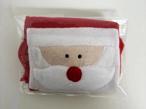 Close-up of Santa Claus fabric bottle cover with soft plush texture and embroidery
