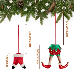 Detailed view of elf and Santa legs Christmas tree ornaments with festive pine decor