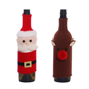 Christmas elk and Santa wine bottle covers made of festive knitted wool on white background