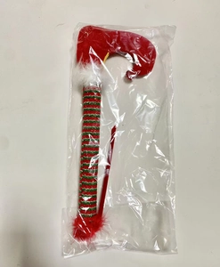 Close-up of plush elf legs Christmas ornament in red and green stripes with fur trim