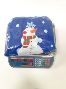 Three-piece set of navy blue snowman cushion covers showing a weight of 0.240kg on scale