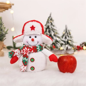 Charming snowman plush doll in knitted hat and scarf with a red apple for holiday decor