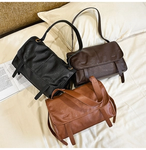Detailed view of three vintage crossbody bags in black, dark brown, and caramel faux leather