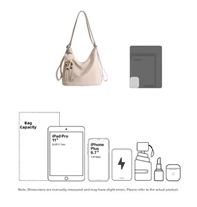 Detail view of large capacity cream tote bag showing iPad and phone storage space
