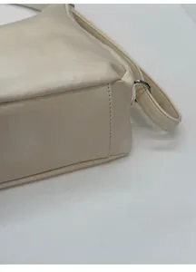 Close-up of the widened bottom structure on this minimalist cream tote bag