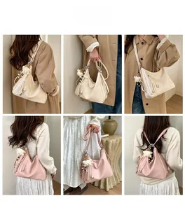 Detailed view of cream and pink tote bag showing fringe accents and versatile straps