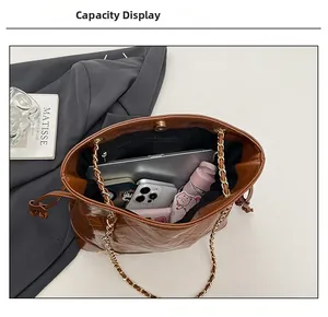Detail showing the large interior capacity of this brown quilted PU leather bucket bag