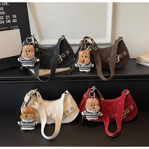 Detail of four hobo bags in black, coffee, cream, and red with dog charms