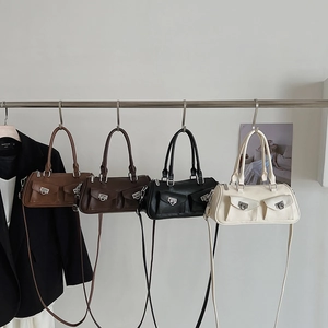 Row of four stylish cylindrical crossbody bags in brown, chocolate, black, and cream white