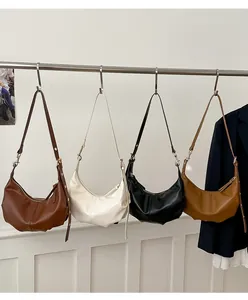 Detailed display of four leather hobo bags in dark brown, cream, black, and caramel colors