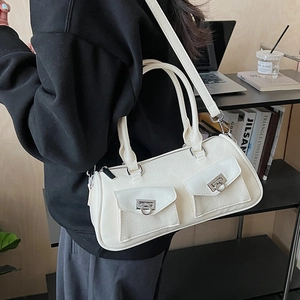 Detail of white baguette handbag with silver double-ring buckles and adjustable strap