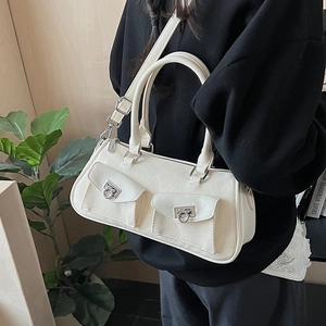 Detail of off-white baguette bag featuring signature silver buckles and front pockets