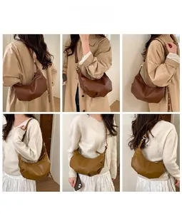 Detail view of vintage pleated crescent bag with adjustable straps in coffee and ginger