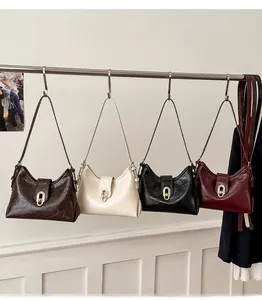 Detail shot of vintage shoulder bags in four colors with gold metal buckles and straps
