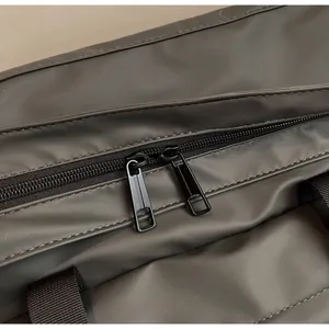 Close-up of smooth dual metal zippers and reinforced stitching on a lightweight tote bag