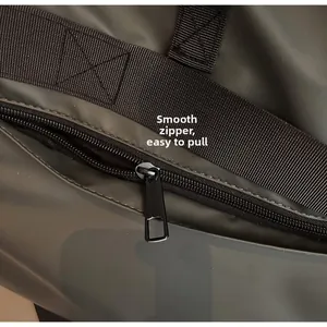 Detail of smooth waterproof metal zipper and matte texture on gray tote bag