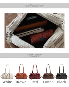 Interior storage capacity of the glossy patent leather Boston bag and color options