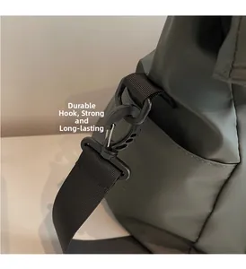 Detail of durable black hook and sturdy reinforced nylon strap on a dark tote bag