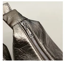 Detail of metallic bronze tote bag with crinkled texture and robust metal zipper hardware