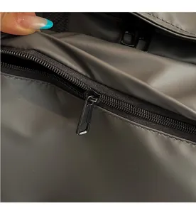 Macro shot of smooth black metal zipper and matte waterproof fabric on tote bag