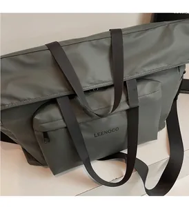 Detail of waterproof nylon tote bag with reinforced handles and durable zip pockets