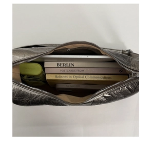 Top view of large silver tote bag with crinkled texture and spacious brown lining