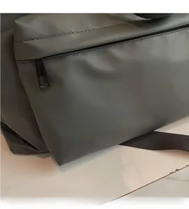 Close-up of soft matte fabric and premium metal zipper on a dark casual tote bag