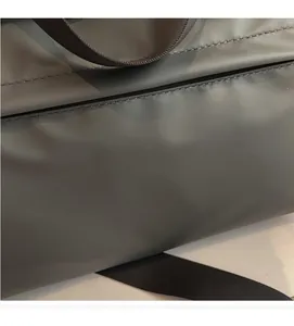 Detail of LEENOCO dark grey tote bag showing waterproof nylon fabric and woven strap