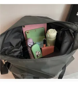 Detail view of large tote bag interior showing spacious storage for tablet and umbrella