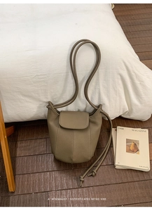 Detail of khaki grey pebble leather pumpkin bag with vertical stitching and round strap