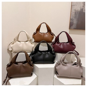 Close-up of stylish faux leather cloud bags in six colors with adjustable straps