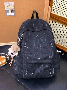 Large black backpack with white lightning pattern and bear keychain for students