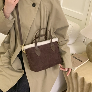 Brown faux suede bucket bag with white plush trim and golden hardware for winter