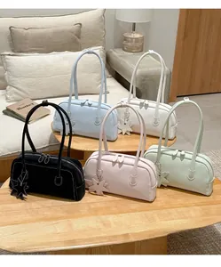 Detail of minimalist rectangular tote bags in five colors with star leather charms
