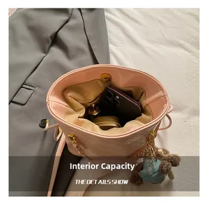 Detail of pink quilted bucket bag showing interior capacity for phone and cosmetics