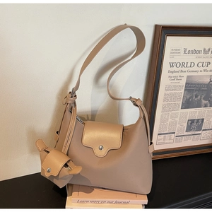 Detail of beige nylon shoulder bag with detachable mini pouch and magnetic metal snap closure