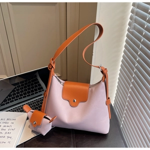 Detail of pink and orange two-piece shoulder bag set with mini coin purse on desk