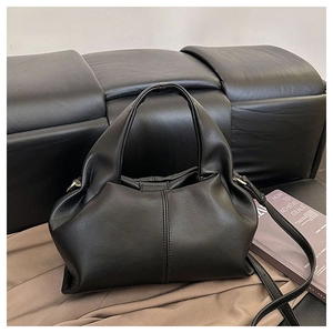 Detail view of black pleated cloud bag with smooth PU leather texture and gold hardware