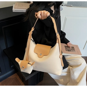 Detail of canvas tote bag with leather trim and matching mini coin purse attachment