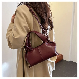 Close-up of wine red dumpling bag with soft pleated leather and slim shoulder strap