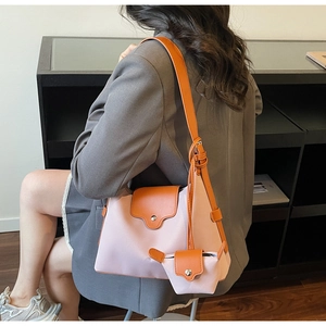 Detail of pink and orange crossbody bag with mini pouch and stylish tassel accent