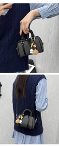 Detail of Boston mini bag featuring fine texture fabric and adjustable shoulder strap