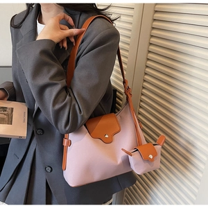 Detail of contrast color crossbody bag in purple fabric and orange leather with mini pouch