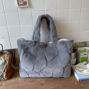 Close-up of gray faux fur tote bag showing plush petal-shaped texture and spacious interior