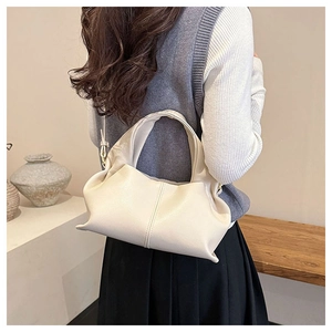 Detail of soft pleated cream leather shoulder bag with exquisite vertical stitching accents